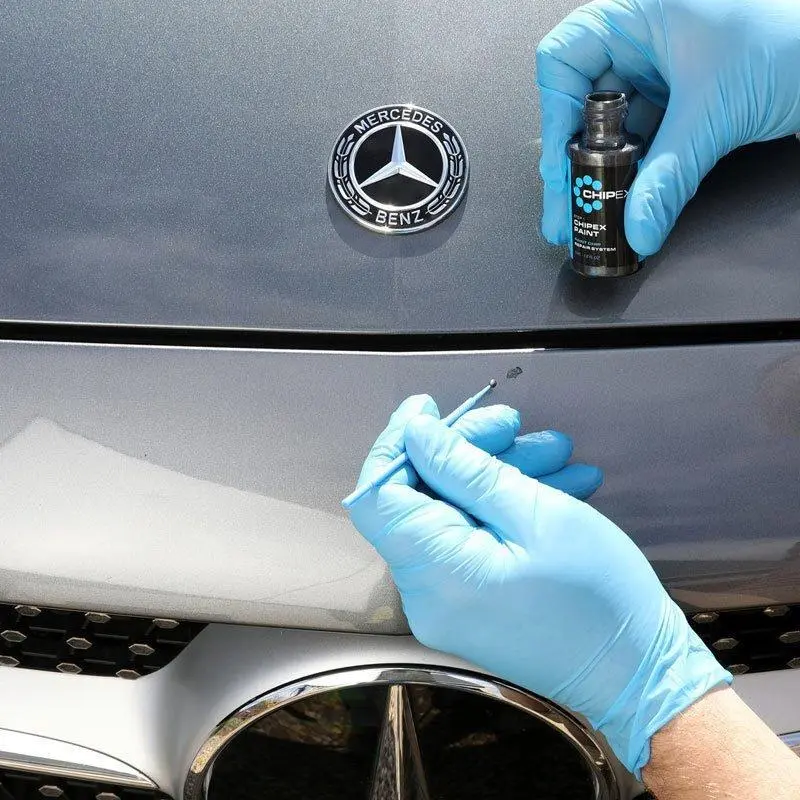 Person with gloves using the Chipex Paint on a Grey Car