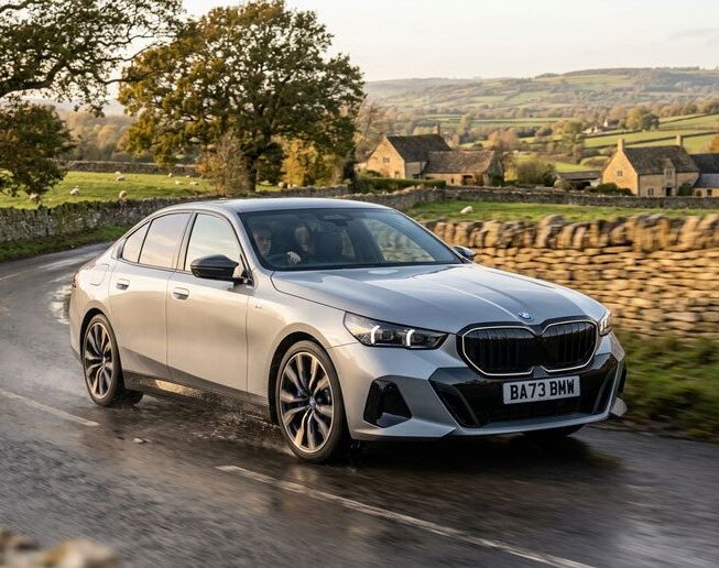 BMW car driving on country lane